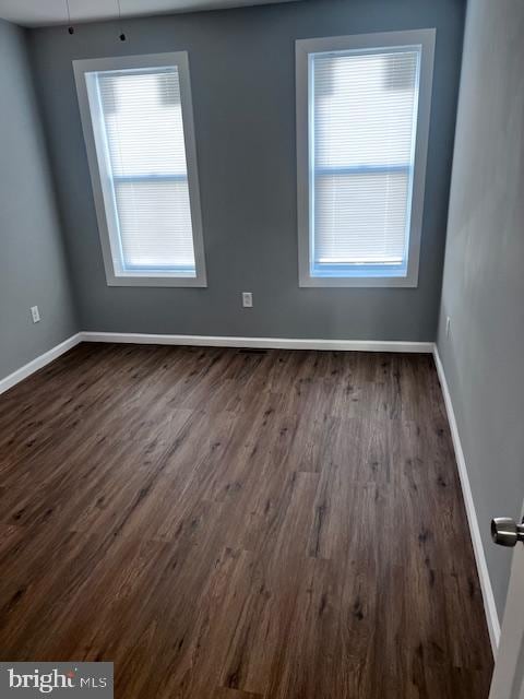 spare room with dark hardwood / wood-style flooring