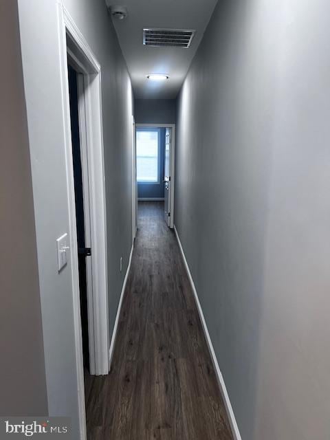 hallway featuring dark hardwood / wood-style flooring