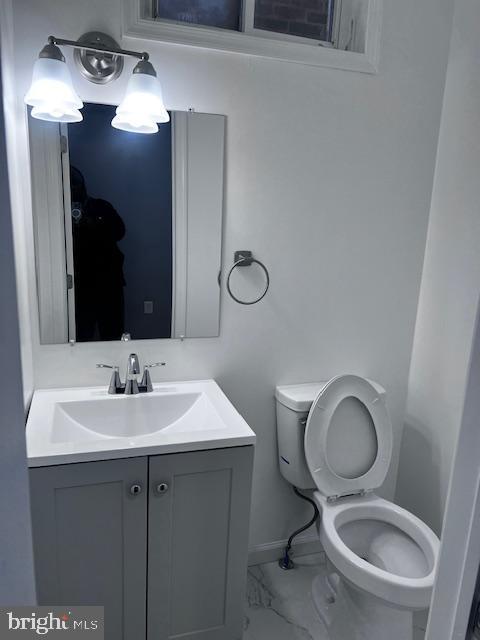 bathroom featuring vanity and toilet