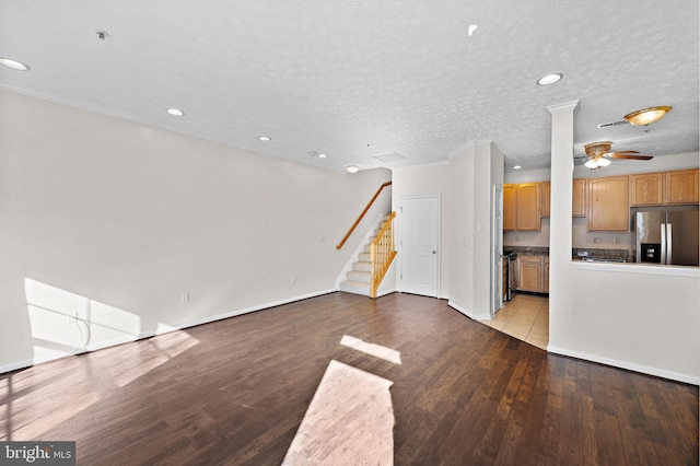 unfurnished living room featuring a textured ceiling and light hardwood / wood-style floors