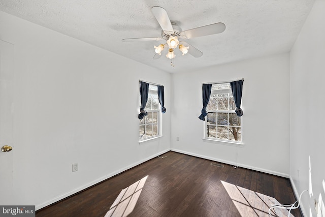 empty room featuring a textured ceiling, ceiling fan, and hardwood / wood-style flooring