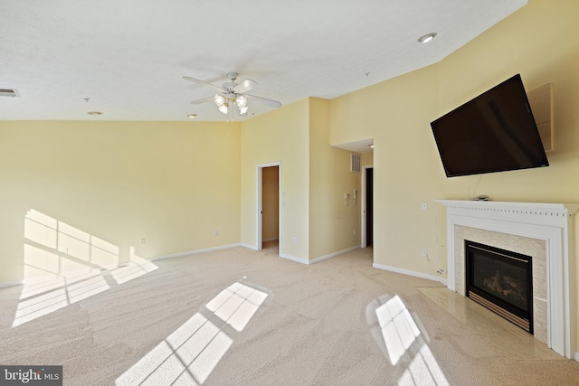 unfurnished living room with a high ceiling, ceiling fan, and light carpet