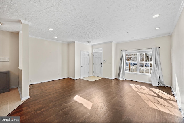 unfurnished living room featuring a textured ceiling, hardwood / wood-style floors, and ornamental molding