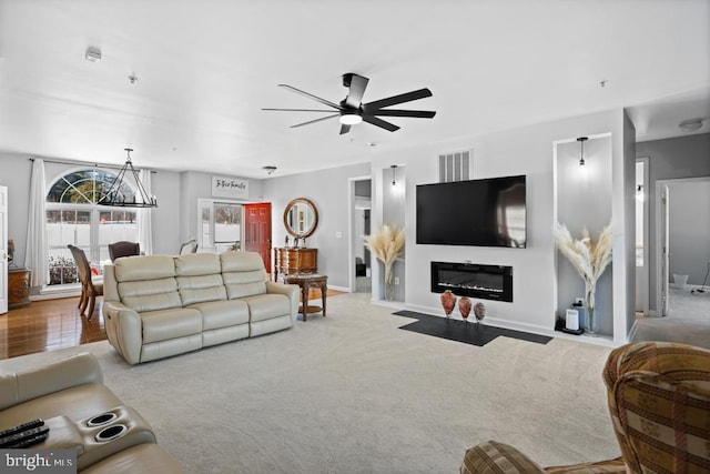 carpeted living room featuring ceiling fan