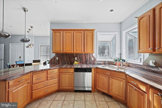 kitchen featuring dishwasher, hanging light fixtures, kitchen peninsula, sink, and tasteful backsplash