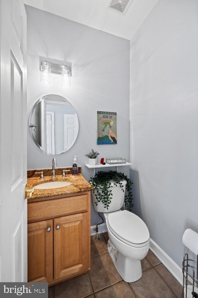 bathroom with vanity, tile patterned floors, and toilet