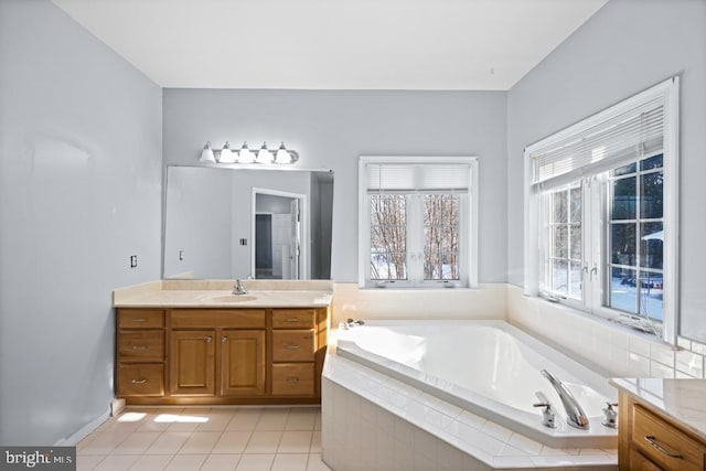 bathroom with vanity, tile patterned floors, and a relaxing tiled tub