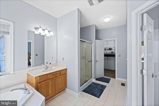 bathroom with independent shower and bath, tile patterned flooring, and vanity