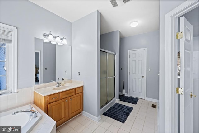 bathroom featuring tile patterned flooring, shower with separate bathtub, and vanity