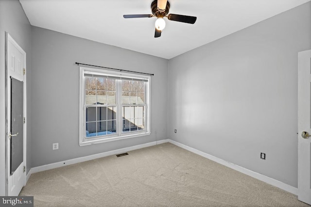 unfurnished room featuring ceiling fan and light colored carpet