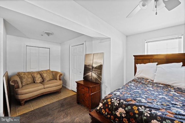 tiled bedroom featuring ceiling fan and a closet