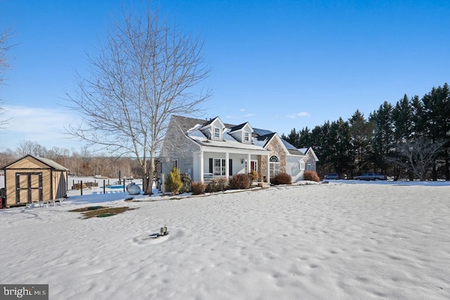 cape cod home with a shed