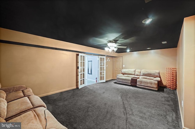 carpeted cinema room with ceiling fan and french doors