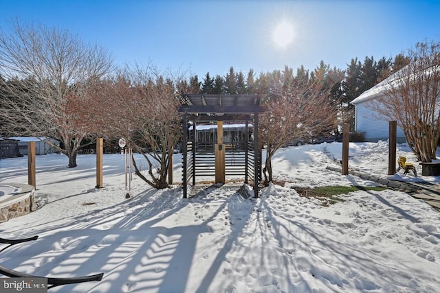 yard covered in snow featuring a playground