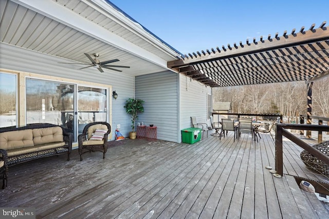 wooden deck with ceiling fan and a pergola