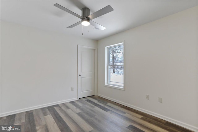 spare room featuring wood-type flooring and ceiling fan