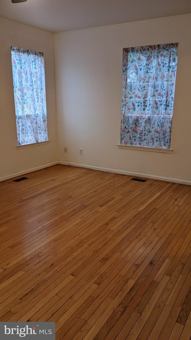 spare room with light hardwood / wood-style flooring