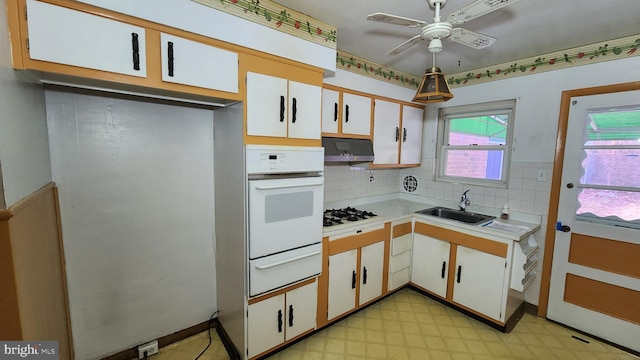 kitchen featuring sink, exhaust hood, white cabinets, and white appliances