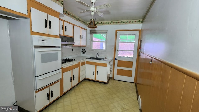 kitchen featuring white appliances, sink, and white cabinets