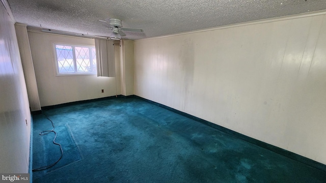 carpeted empty room featuring ceiling fan and a textured ceiling