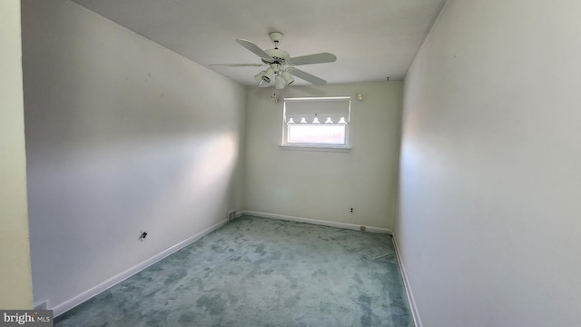 spare room with light colored carpet and ceiling fan