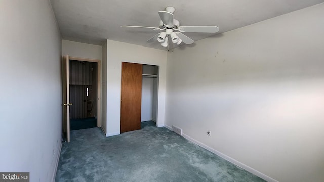 unfurnished bedroom featuring ceiling fan, a closet, and dark colored carpet