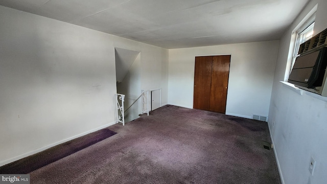 spare room with dark colored carpet