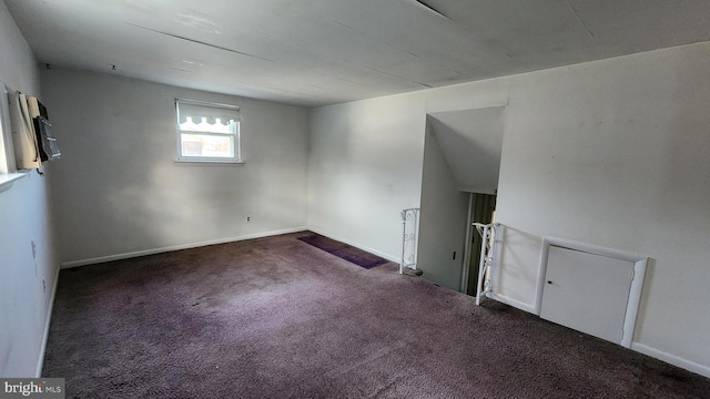 basement featuring dark colored carpet