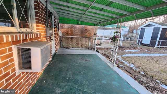 view of patio / terrace featuring a shed and ac unit