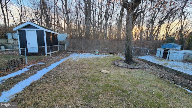 yard at dusk with a storage shed