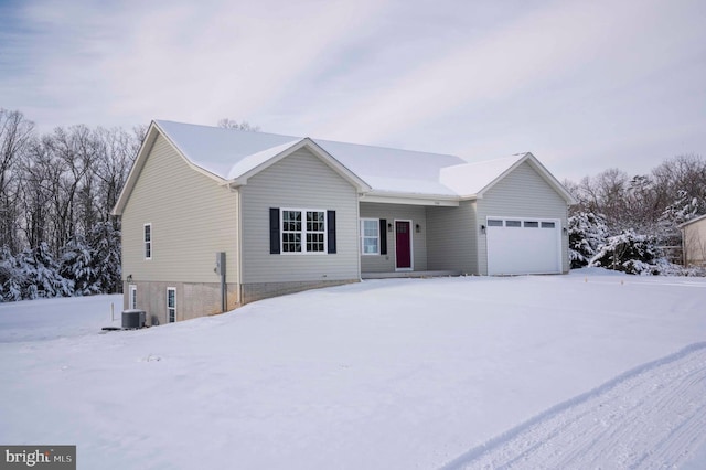 ranch-style house with a garage and central air condition unit