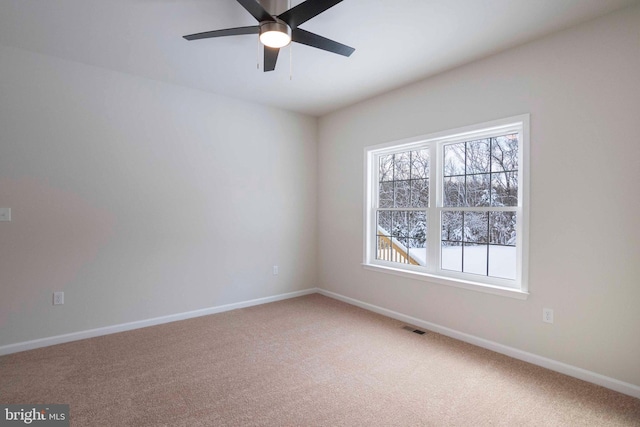 carpeted empty room featuring ceiling fan