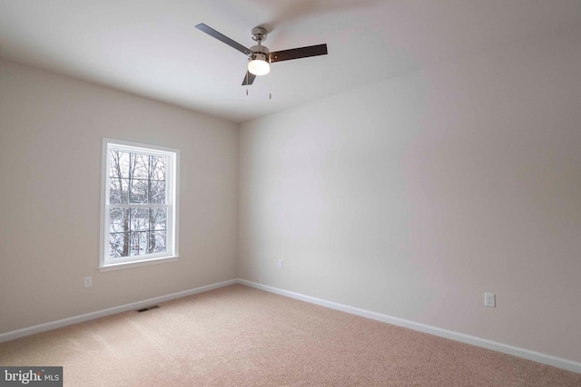 unfurnished room featuring ceiling fan and carpet flooring