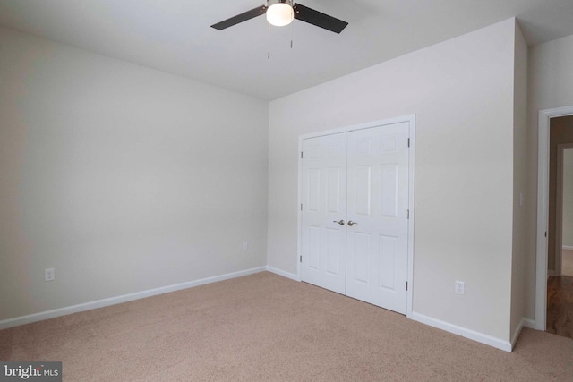 unfurnished bedroom featuring a closet, ceiling fan, and carpet flooring