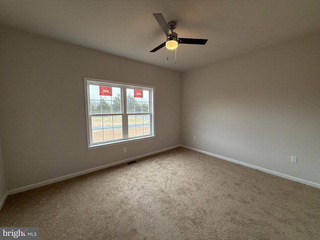 spare room featuring carpet flooring and ceiling fan