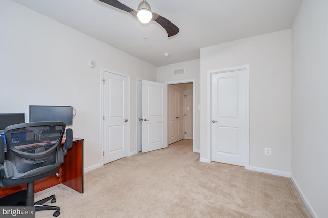 home office featuring ceiling fan and light carpet