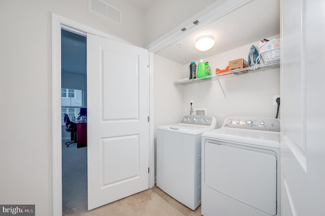 laundry area featuring light carpet and washing machine and clothes dryer