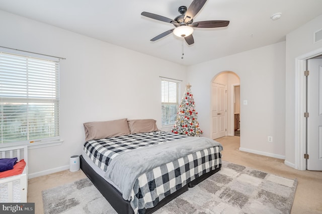 bedroom featuring light carpet and ceiling fan