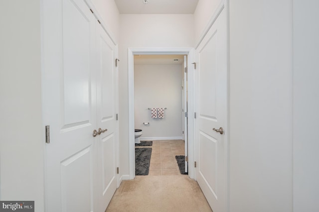 corridor featuring light tile patterned floors