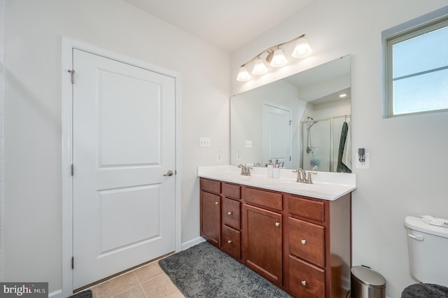 bathroom with toilet, vanity, tile patterned floors, and an enclosed shower