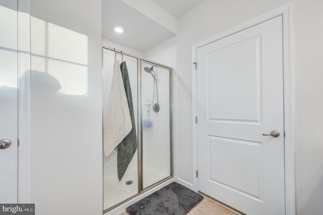 bathroom with tile patterned floors and a shower with shower door