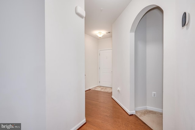 corridor with light wood-type flooring