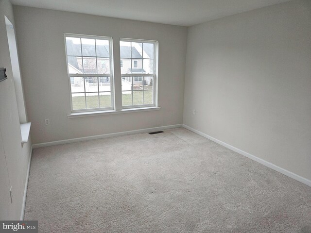 empty room featuring light colored carpet