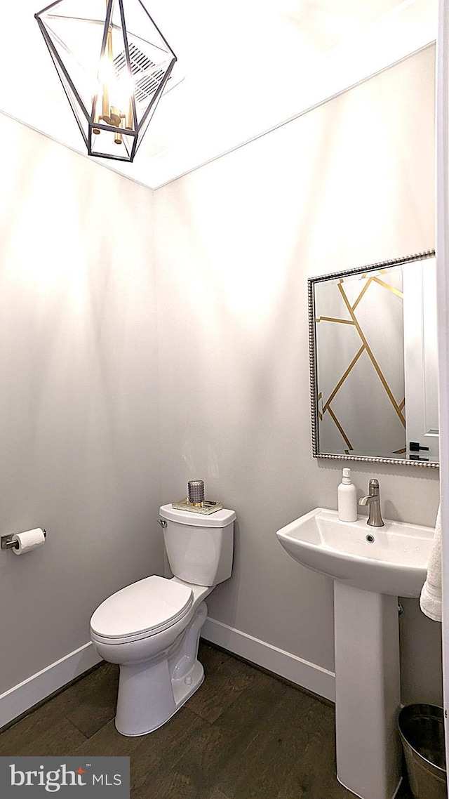 bathroom featuring hardwood / wood-style floors and toilet