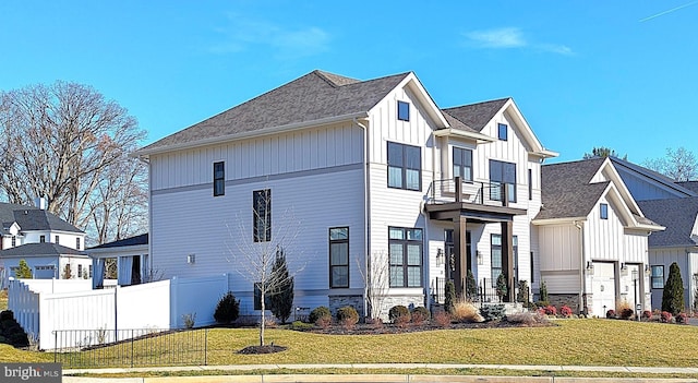 view of front of house featuring a balcony and a front lawn