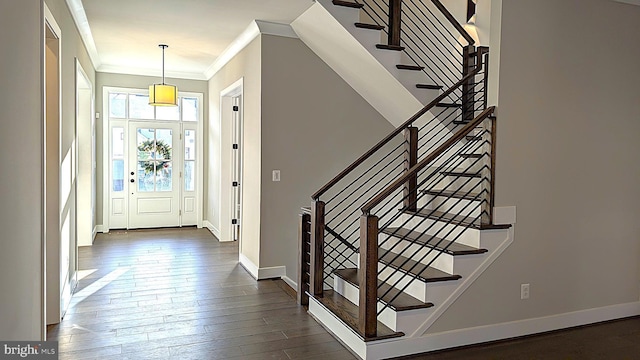 entryway featuring crown molding and dark wood-type flooring