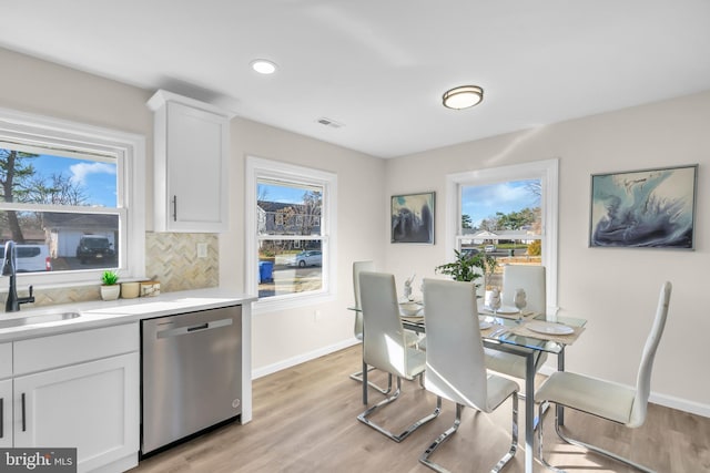 dining area with light hardwood / wood-style floors and sink