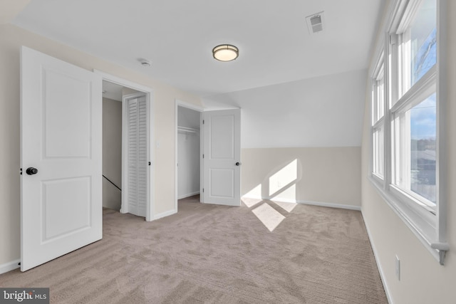 unfurnished bedroom featuring light carpet