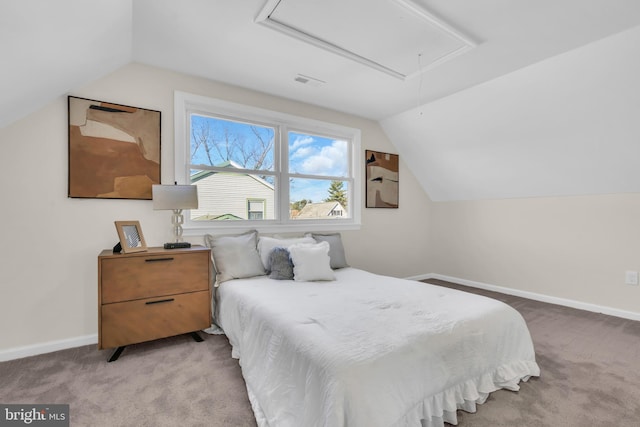 carpeted bedroom with lofted ceiling