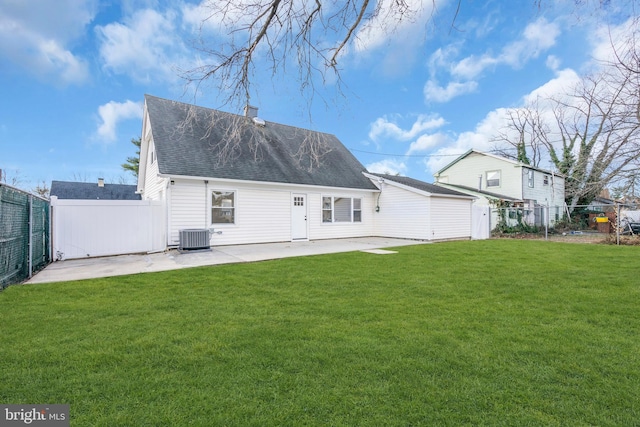 back of property featuring a lawn, central air condition unit, and a patio